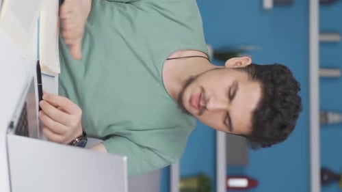 Young Adult Video Calling at Desk with Laptop