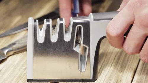 Sharpening scissors on a grinding machine, sparks are flying