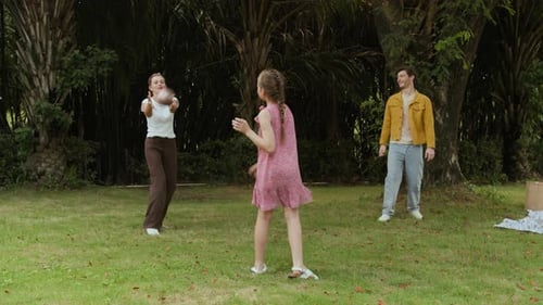 Daughter and Parents Playing Ball Game in Park