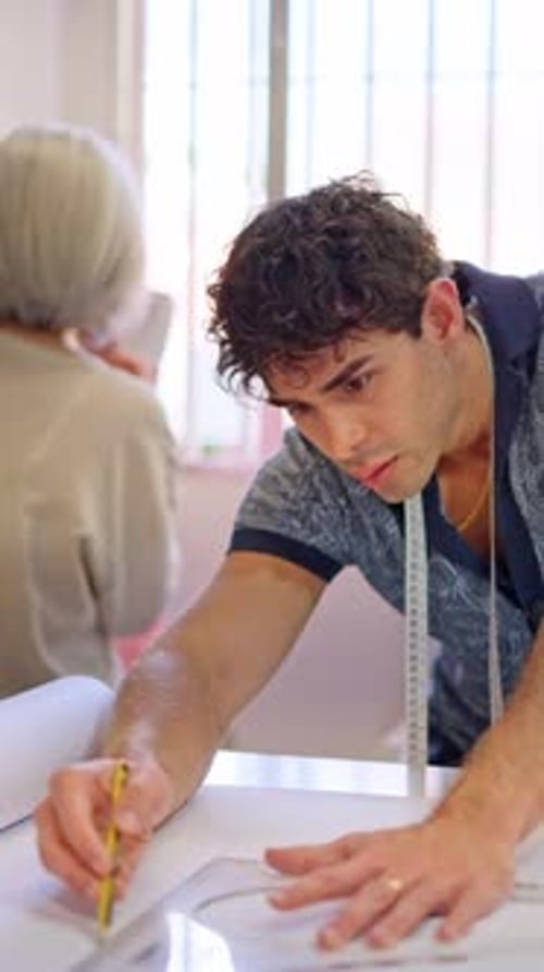 Young Tailor Drawing a Sewing Pattern
