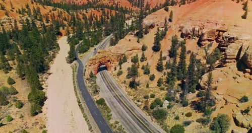 Rocky arch over the motorway in National park in United States. Bright sunny day in Arches Canyons