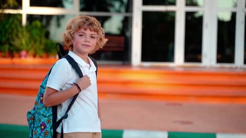 Portrait of School Student Child Boy Girl with Backpack Looking at Camera Smiling in Yard During