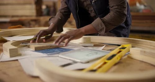 Carpenter, hands and pencil with measurement for construction, furniture or project
