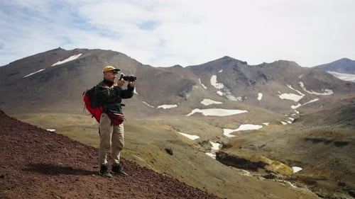 Photographer Traveler Taking Picture By Professional Photo Camera From Top Of Mount