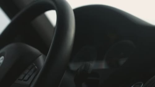 Confident businessman behind the wheel of a luxurious automobile on the open road