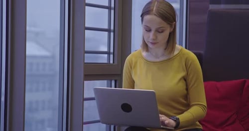 Talented Digital Marketing Specialist Working on Laptop in the Office in the Evening