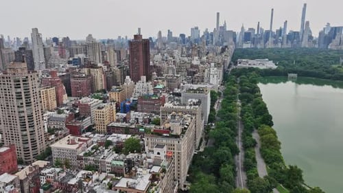 An aerial view of a city with a lake in the foreground
