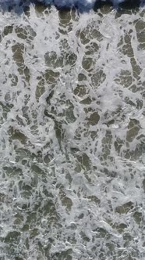 Vertical Video of Ocean Waves Rolling On Shoreline