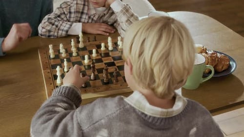 Grandparent Teaching Kids to Play Chess Game