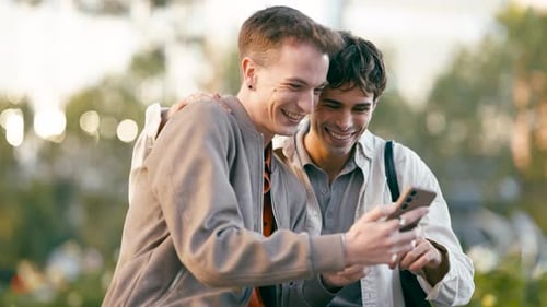 Affectionate Men Looking at Smartphone in Urban Setting