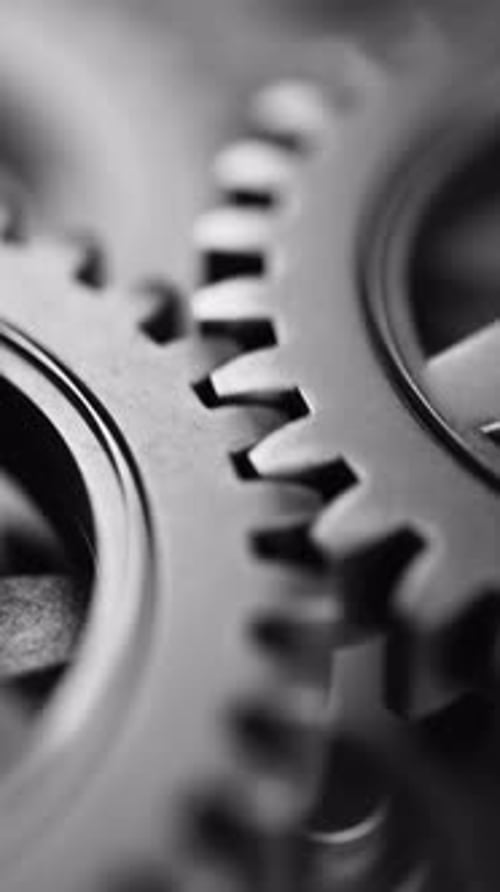 Nahtlose Schleife aus ineinandergreifenden Metallzahnrädern, die sich drehen.