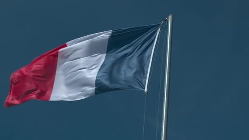 French Flag Waving Against Blue Sky