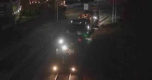 Freight train repair cars at night