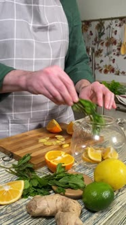Making citrus hot beverage at domestic kitchen