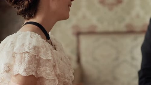 Elegant Woman in Ornate Dress at Table