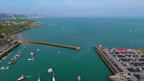 Aerial reveal, seaside town attractions, visitor parking, vessel moorings