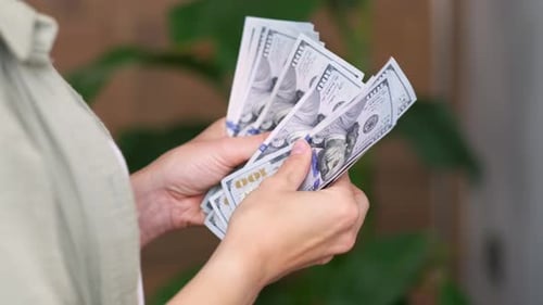 Showing Cash Money 1000 American Dollars Banknotes Close Up in Woman Hands Income Winner and