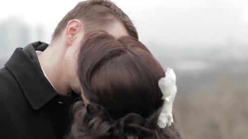 Smiling Couple Kissing in Urban Setting