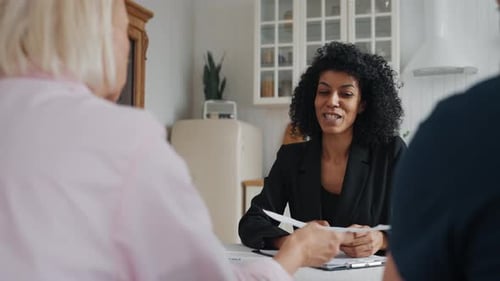 Sale of Real Estate or Legal Advice Meeting of Insurance Agent and Aged Couple Beautiful African
