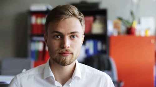 Business, People, Emotion And Facial Expression Concept - Smiling Young Man At Office