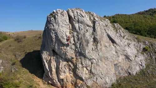 Aerial view of mountain rescuer doing rescue operations hanging on a rope