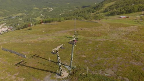 Aerial footage of man sitting on a ski lift pillar