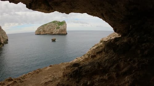 Cave on Rocky Coast with Cliffs on the Mediterranean Sea