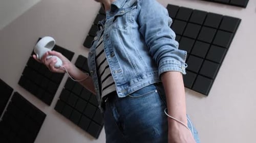 Young Woman Using Virtual Reality Headset Indoors