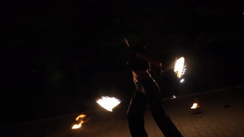 Woman Performing with Fire Poi at Night