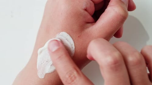 Cosmetic Scrub Applied to Hand in Close Up