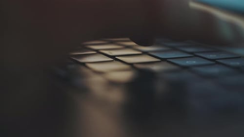 Fingers Typing on a Black Laptop Keyboard