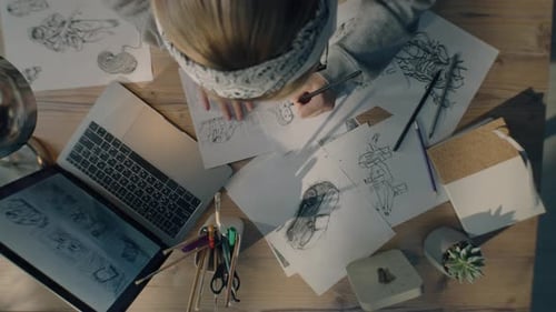 Young Woman Artist Draws Pencil Sketches Works on Storyboard of a Comic Top View