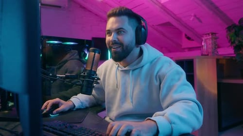 Happy Young Man Caucasian Guy Male Celebrating Victory Gaming on Computer Stream with Headphones and