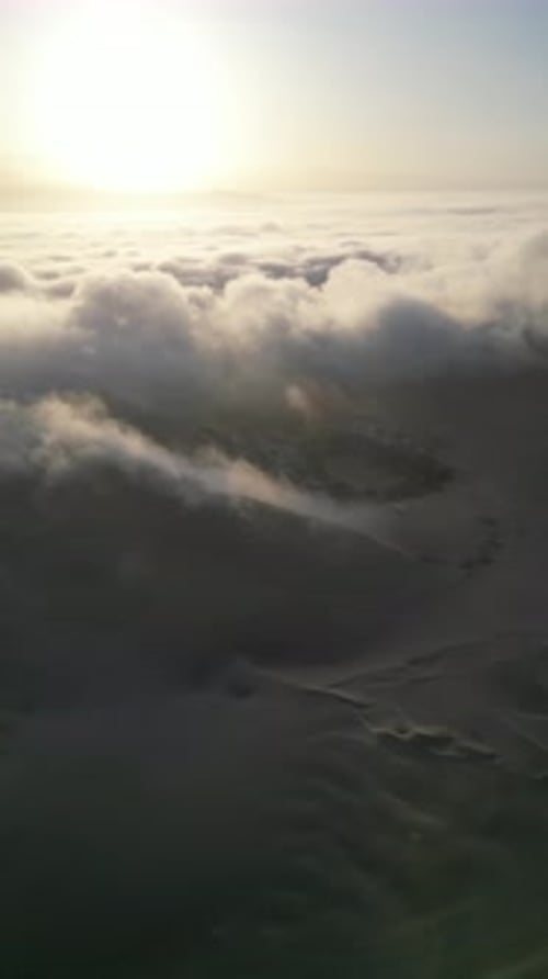 Aerial video above fog in the dunes of Huacachina Peru