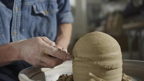 Potter Shaping Clay on Spinning Wheel