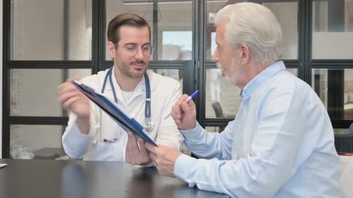 Doctor Explaining Form to Senior Male Patient