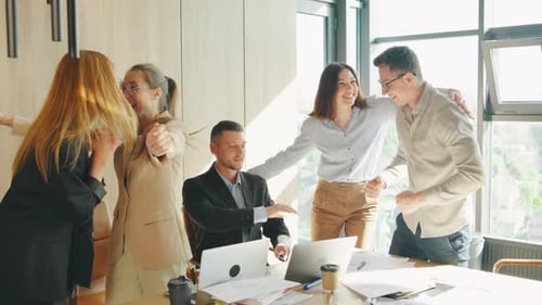 Excited Business Team Celebrates a Successful Project