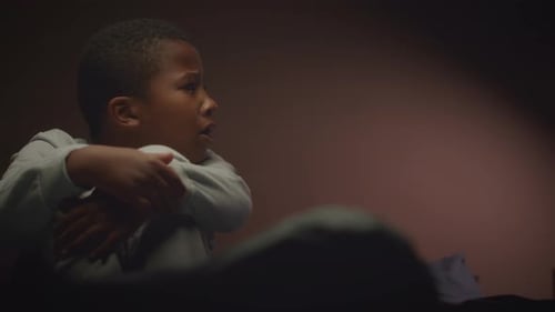 Scared Little Boy in Dark Room with Flickering Light