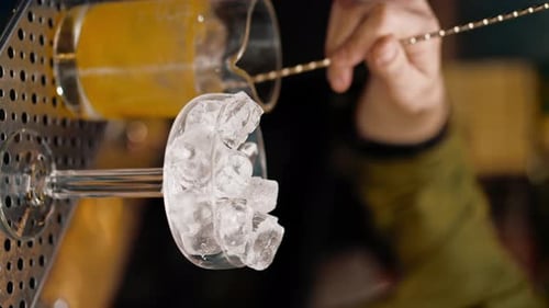 Glass of Ice and Preparation of Beverage