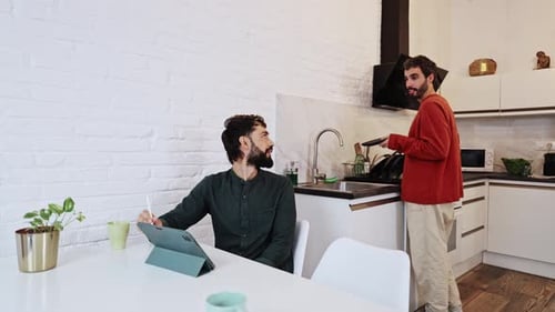 Men Conversing in Modern Kitchen