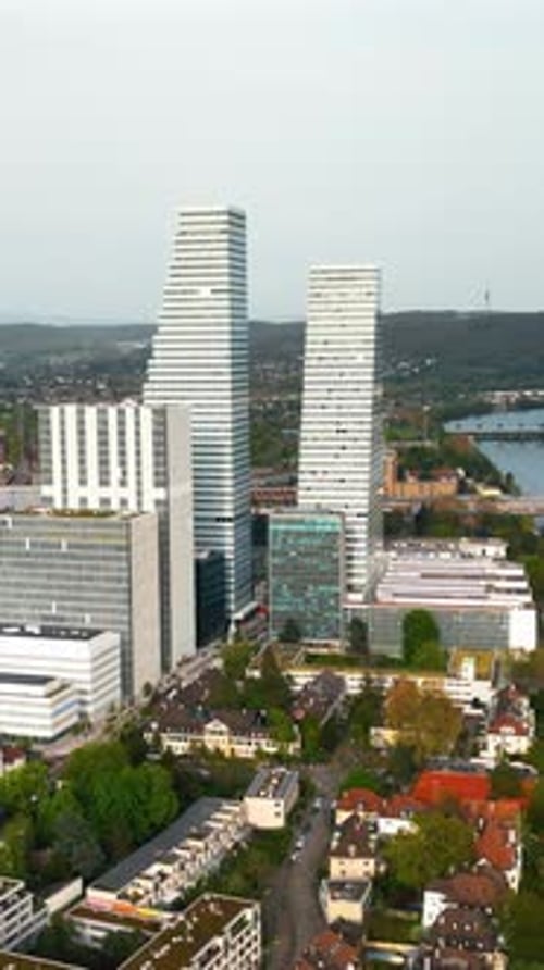 Aerial, drone view of the Roche Tower (Building 1) in Basel, Switzerland. Vertical
