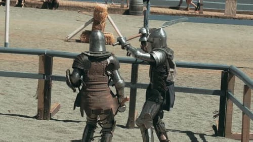Group of armored knights fighting with sword, hatchet and protective shield. Slow motion footage. Kr