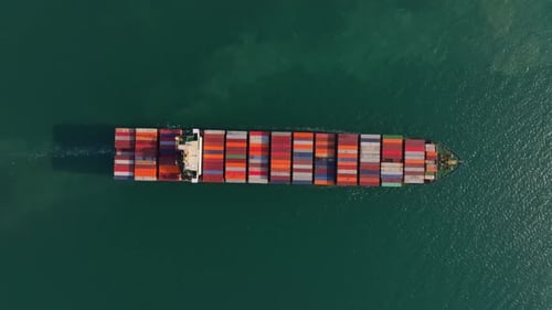 Trade ship navigating out of the harbor, Thailand