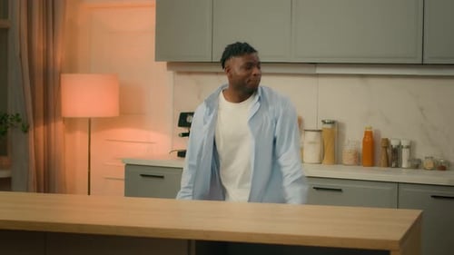 Man Dances in Kitchen with Modern Flair