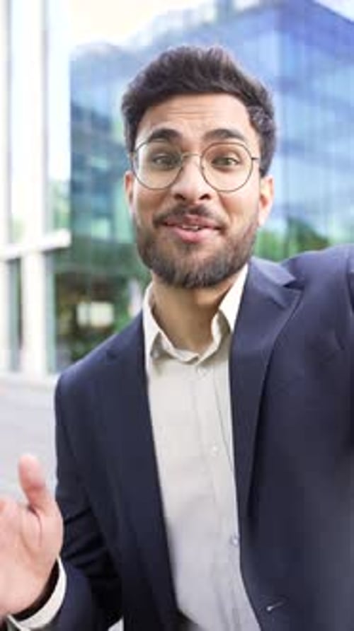 Smiling Man in Suit Talking to Camera Outside