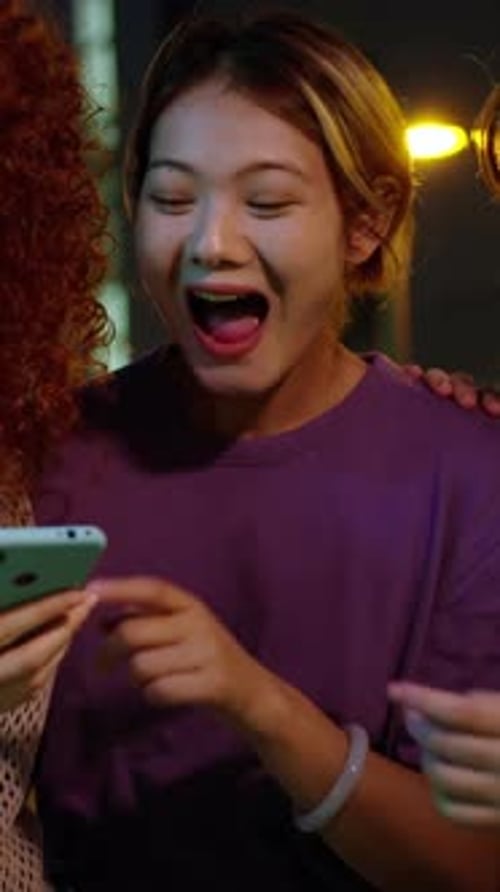 Friends Share a Laugh while Looking at Phone