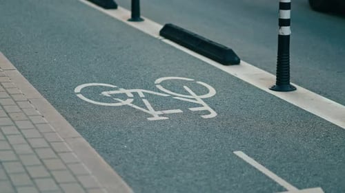 The Bike Lane Markings on a City Street are Being Closely Examined in Slow Motion to Ensure Their