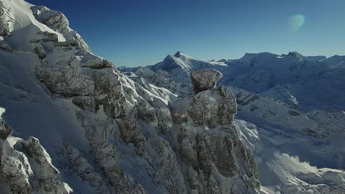 Capture the Stunning View of a Breathtaking Winter Mountain Range in the Daylight