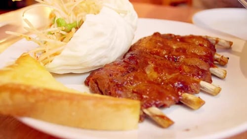 Appetizing Ribs with Salad and Bread on Plate