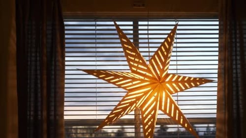 Illuminated Moravian Star Decoration Hanging in Window